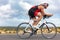 Cycling sport athlete man biking on triathlon bike. Fit male cyclist on professional triathlon bicycle wearing time