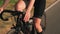 Cycling at sunrise. Woman pedaling bike at sunset, close up of bike gear. Cyclist twists pedals on bicycle. Cycling gear, bicycle