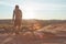 Cycling towards the sun. Full length shot of a young male athlete mountain biking in the wilderness.