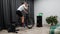 Cycling woman drinks water while training on smart bicycle trainer at home looking at computer screen. Indoor cycling concept