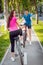 Cycling young couple. In the park. Beautiful bicycle lane.