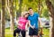 Cycling young couple. In the park. Beautiful bicycle lane.