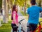 Cycling young couple. In the park. Beautiful bicycle lane.