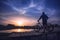 The cyclist admires the wonderful sunset on the bridge