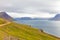 Cyclist along the road to the Iceland fjords