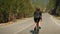 Cyclist on bicycle riding in mountains. Triathlete road biking through mountains at sunset. Athlete riding bicycle on long flat ro