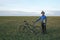 Cyclist with Bicycle standing on field path