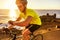 Cyclist biking looking at smartwatch riding bike