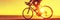 Cyclist biking on road bike sunset banner