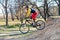 Cyclist in a bright sweater and red shorts riding a bicycle, downhill. Active lifestyle