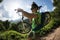 Cyclist carrying mountain bike on mountain trail