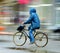 Cyclist on the city roadway in rainy day