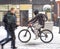 Cyclist on the city roadway on snowy day in motion blur