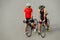 Cyclist couple standing on a concrete floor with bikes between their legs