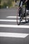 Cyclist crosses the city road with pedestrian crossing on road b