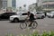 A cyclist crosses the HI Roundabout Bundaran HI with Welcome Monument Tugu Selamat Datang in the middle