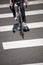 Cyclist crosses the road on pedestrian crossing marked with zebra crossing