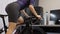 Cyclist is cycling and training on stationary bicycle simulator. Home activity