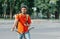 Cyclist with delivery. Happy courier with backpack, smart watch and smartphone, sits on bicycle