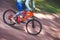 The cyclist descends from the mountain on an orange bicycle, motion blur