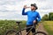 Cyclist drinks water on a background sky