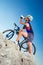 Cyclist drinks water on top of a mountain