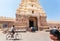 Cyclist driving past the 10th century Ranganthaswamy temple with carved gate gopuram