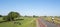 cyclist on dutch dike near river rhine in the netherlands under blue sky with cattle in meadow