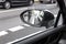 Cyclist in the exterior mirror of a car