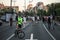 Cyclist with a face mask in front of Anti Covid 19 restrictions protesters by Serbian parliament in belgrade during the anti vucic