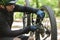 Cyclist fixing the bike chain while riding in the forest