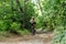 Cyclist in full gear rides on forest trails on a gravel bicycle