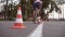 Cyclist go round traffic cones. Young handsome man riding a vintage bicycle. Sporty guy cycling at the park. Healthy