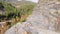 Cyclist going down serpentine road in mountains. Athlete cycling on mountain pass. Bicycle rider descending mountain road on high