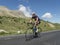 Cyclist in the graslands of the high Alps