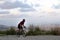 Cyclist grasping the handlebars of a road bike observing the city of Barcelona