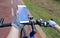 Cyclist hands use gps navigator on smartphone while biking