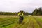 Cyclist hiker rides on a dirt road through a field