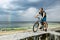 The cyclist with his bike looking at the horizon of the sea and