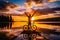 Cyclist with his hands up looking at a sunset on the edge of a lake.