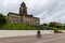 A cyclist passes the Memorial Gardens and Wallasey Town Hall