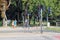 Cyclist and pedestrians wait for green traffic light at crossroads of big street