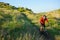 Cyclist in Red Jacket Riding Mountain Bike on the Beautiful Spring Trail. Travel and Adventure Sport Concept