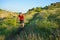 Cyclist in Red Jacket Riding Mountain Bike on the Beautiful Spring Trail. Travel and Adventure Sport Concept