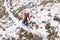 Cyclist in Red Riding Mountain Bike on the Snowy Trail. Extreme Winter Sport and Enduro Biking Concept.