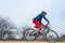 Cyclist in red shorts and blue sweater rides a bicycle, active lifestyle