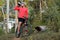 Cyclist resting and drinking isotonic drink in tropical forest.