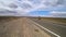 A cyclist rides on an asphalt road in the steppes of Mongolia.