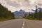 Cyclist rides on highway toward glacier