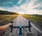 Cyclist rides on the meadov dirt road on a Cyclocross bike.